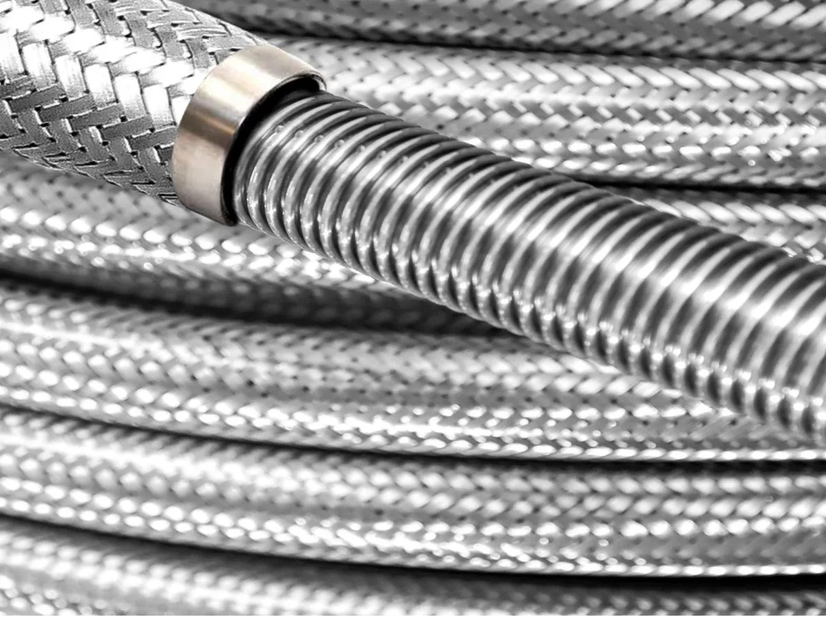 Stainless steel braided corrugated hose terminating in a stainless ferrule, with the corrugated core visible beyond the braid